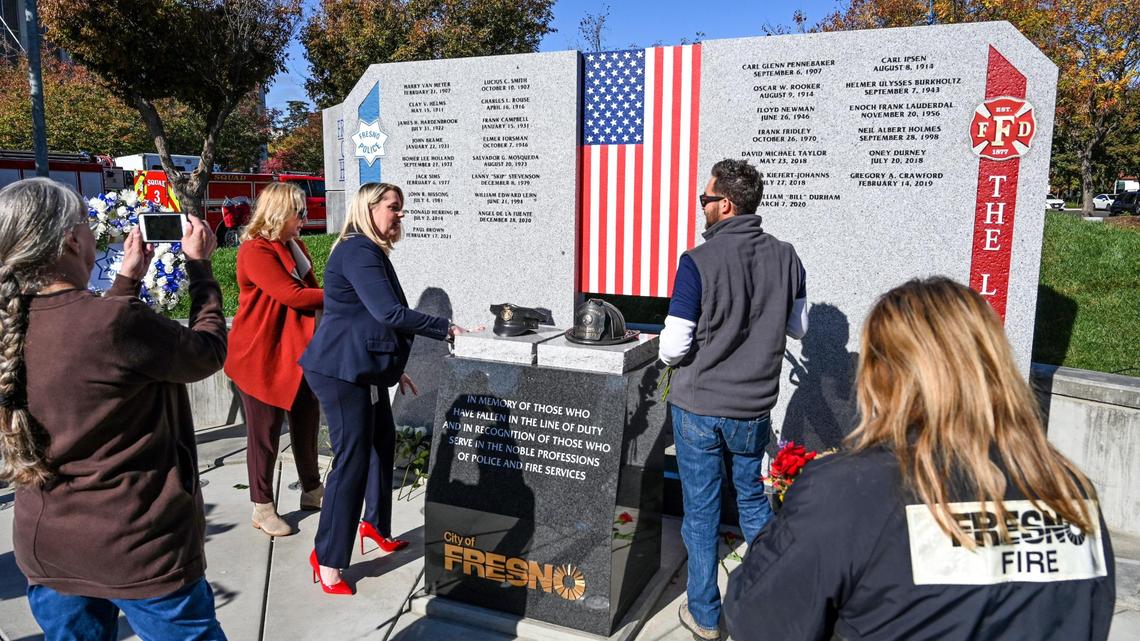 Visitors get a close-up look at the new First Responders Memorial honoring city police officers and firefighters who lost their lives after an unveiling ceremony outside Fresno City Hall on Wednesday, Nov. 2, 2022.
