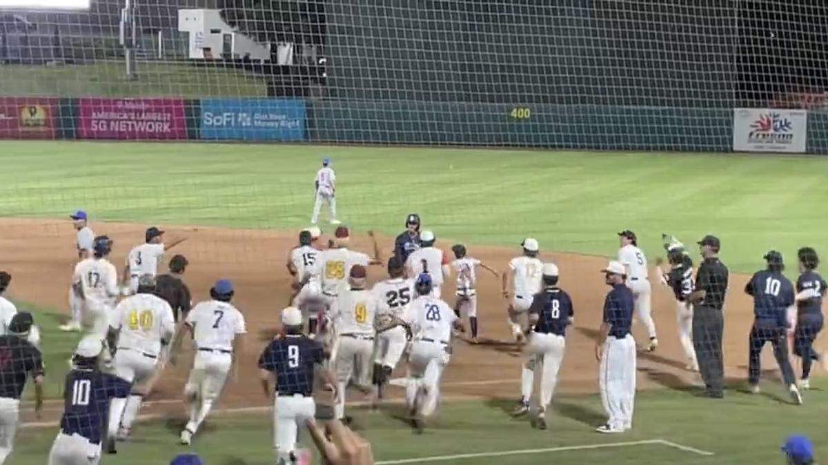 Players from the City mob Nick Stubblefield of Bullard High after he delivered a walk-off hit in a 4-3 victory over the County on Sunday, June 2, 2024.