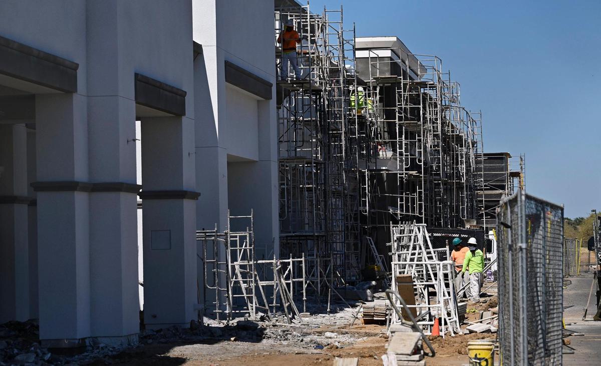 Construction workers are seen on a new large structure at the expanding Loma Vista Marketplace shopping center on the southwest corner of Shaw and Leonard avenues, seen Thursday, July 10, 2025 in Clovis.