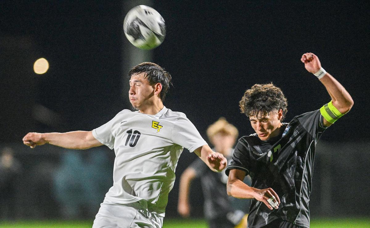 Edison’s Anthony Verduzco, left, battles Clovis North’s Brenen Clay for the ball in the first half of their Division 1 soccer final at Clovis North on Thursday, Feb. 27, 2025.
