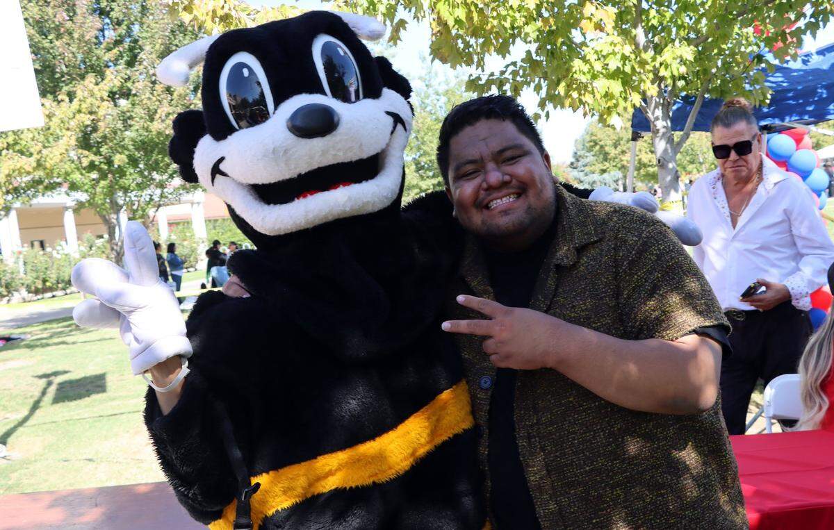 Scoopy, left, poses for a photo with Hanford-born TikTok sensation Leo González at the Feria de Educación at Fresno State on Saturday October 14, 2023.