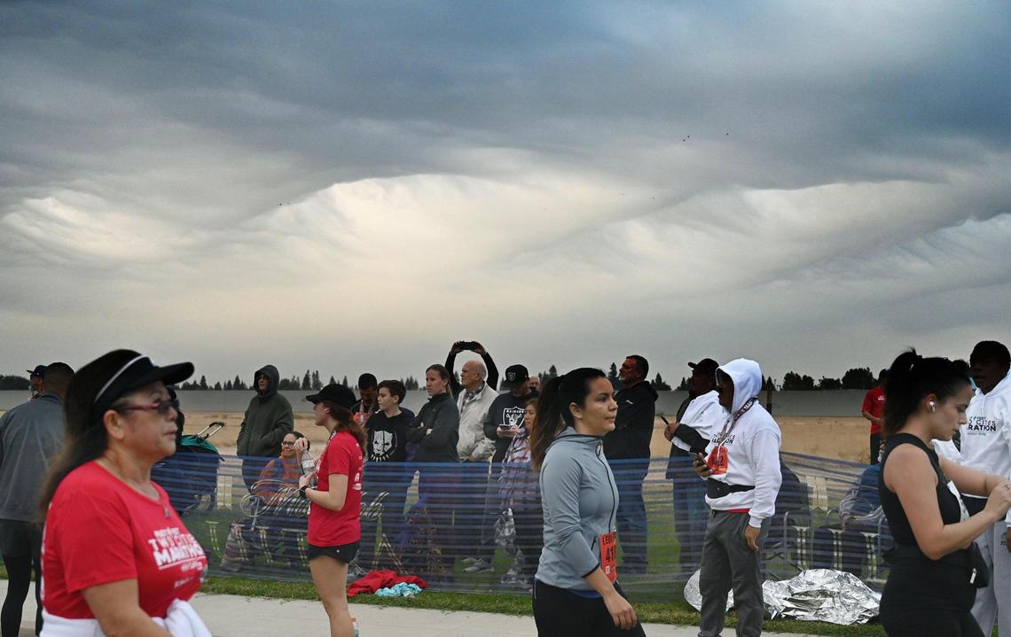 An unusual wave-like formation of clouds from an approaching storm system loomed over runners and spectators at the annual Two Cities Marathon on Sunday morning, Nov. 6, 2022. Weather forecasters expect rain to begin falling Sunday night and continue in waves through overnight Tuesday in the central San Joaquin Valley.