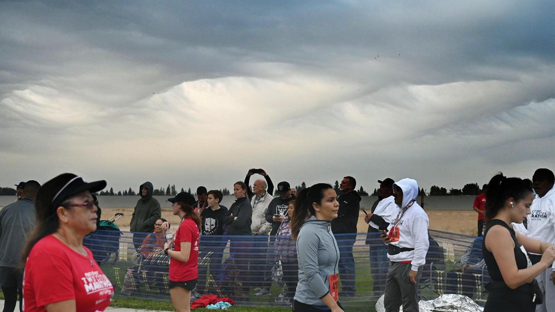 An unusual wave-like formation of clouds from an approaching storm system loomed over runners and spectators at the annual Two Cities Marathon on Sunday morning, Nov. 6, 2022. Weather forecasters expect rain to begin falling Sunday night and continue in waves through overnight Tuesday in the central San Joaquin Valley.
