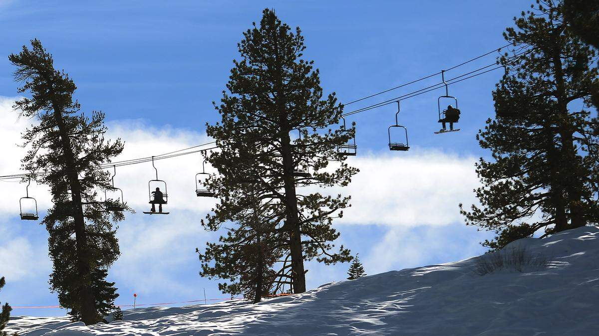 Skiers and snowboarders ride the ski lift to the top of the mountain at China Peak Mountain Resort in December 2018.