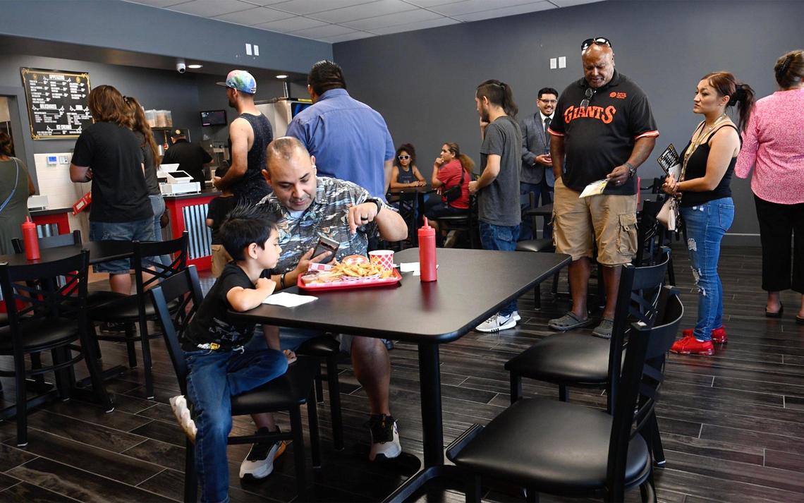 Customers stand in line to order at Sizzlin Smash Burgers on its opening day, first smashburger restaurant for Madera Friday, July 18, 2025 in Madera.