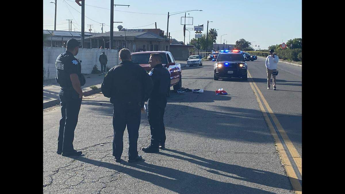 Officers investigate where a man was shot on G Street near Church Avenue in Fresno on Wednesday, April 19, 2023.