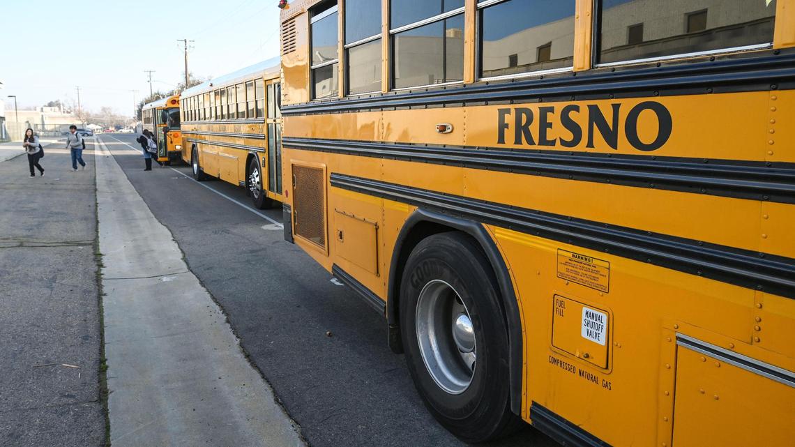 Fresno Unified School District buses arrive at Edison High School to let students off before classes on Friday, Feb. 10, 2023.