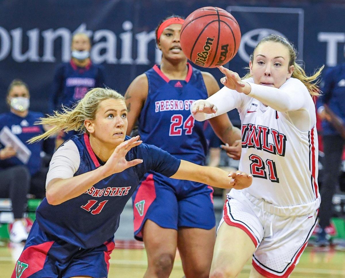 Fresno State’s Maddi Utti, left, and UNLV’s Delaynie Byrne charge toward a loose ball during their game at the Save Mart Center on Saturday, Feb. 27, 2021.