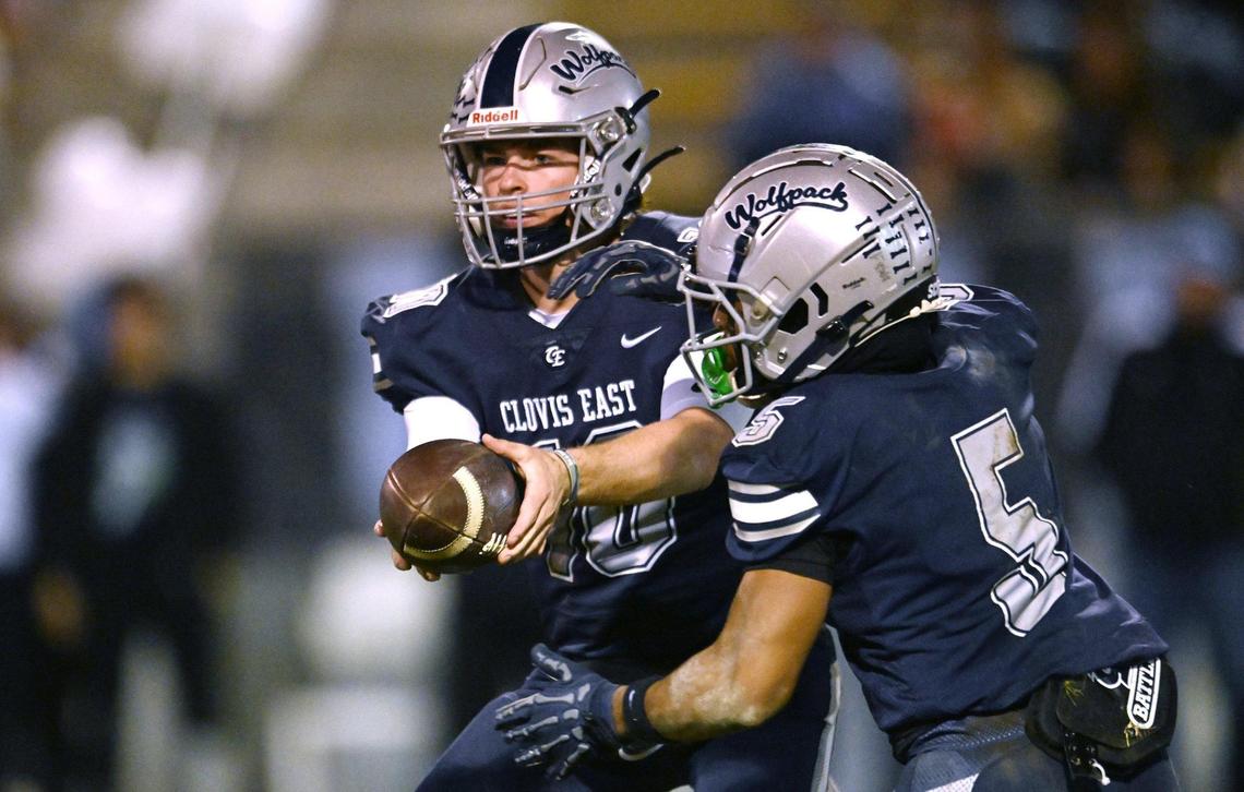 Clovis East quarterback Tyus Miller, left, hands off to Taemell Horton Friday, Nov. 1, 2024. Clovis East beat Clovis North 38-21.