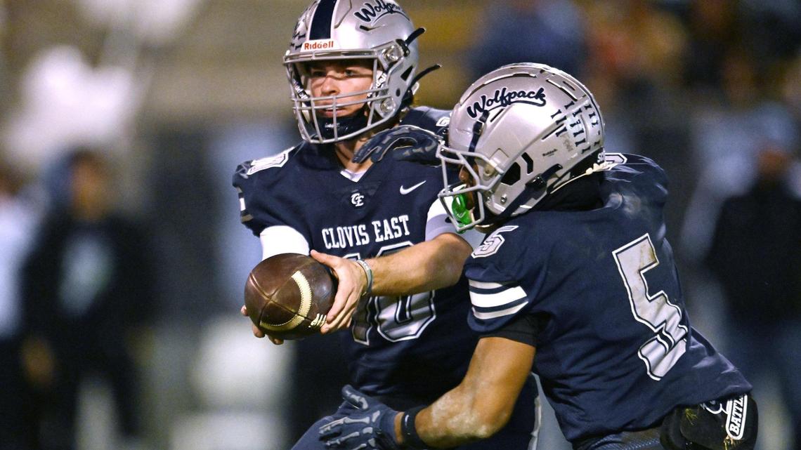 Clovis East quarterback Tyus Miller, left, hands off to Taemell Horton Friday, Nov. 1, 2024. Clovis East beat Clovis North 38-21.