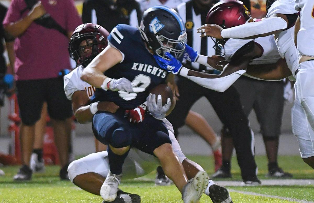 Clovis West’s Brian Evans, background, tackles Bullard’s Nick Stubblefield on a run in first quarter action Friday, Sept. 9, 2022 in Fresno.