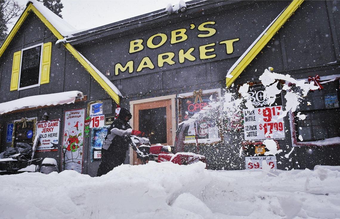 Randi Terrio clears snow from the front of Bob’s Market in Shaver Lake Wednesday, Nov. 27, 2019.