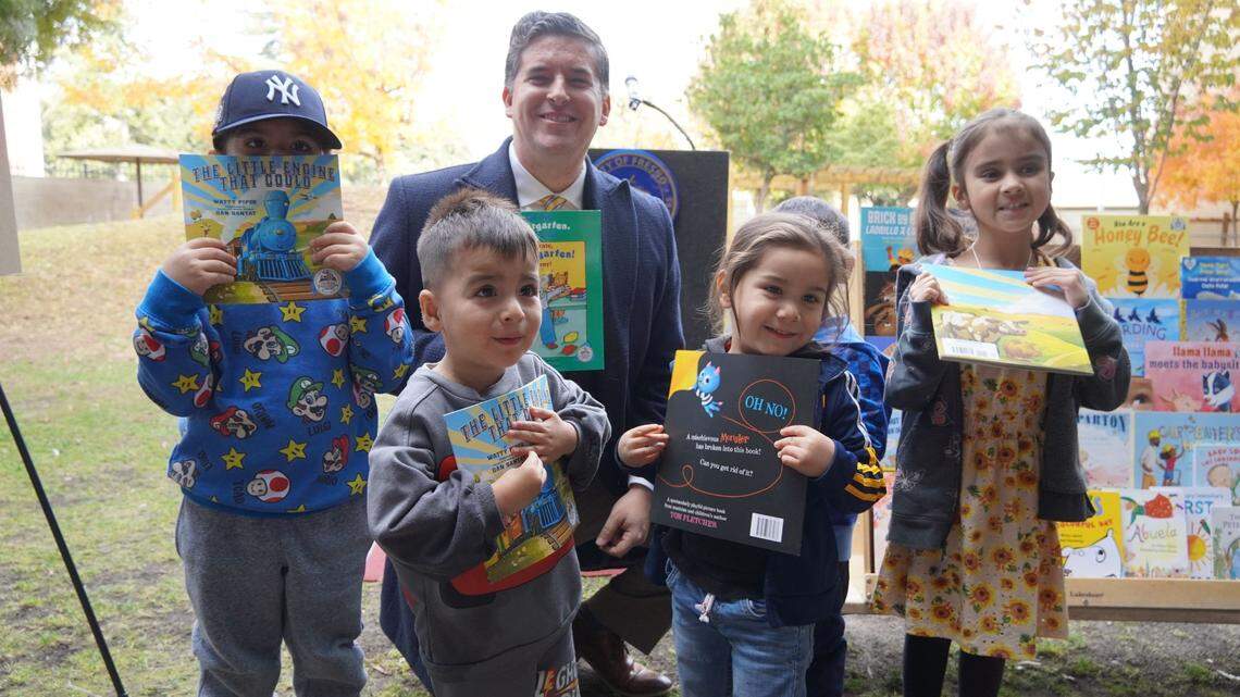 Fresno City Councilmember Tyler Maxwell poses with strikes a pose with four kids in support of children’s literacy. Maxwell set aside $150,000 in federal stimulus funding that will help launch Dolly Parton’s Imagination Library in Fresno County.