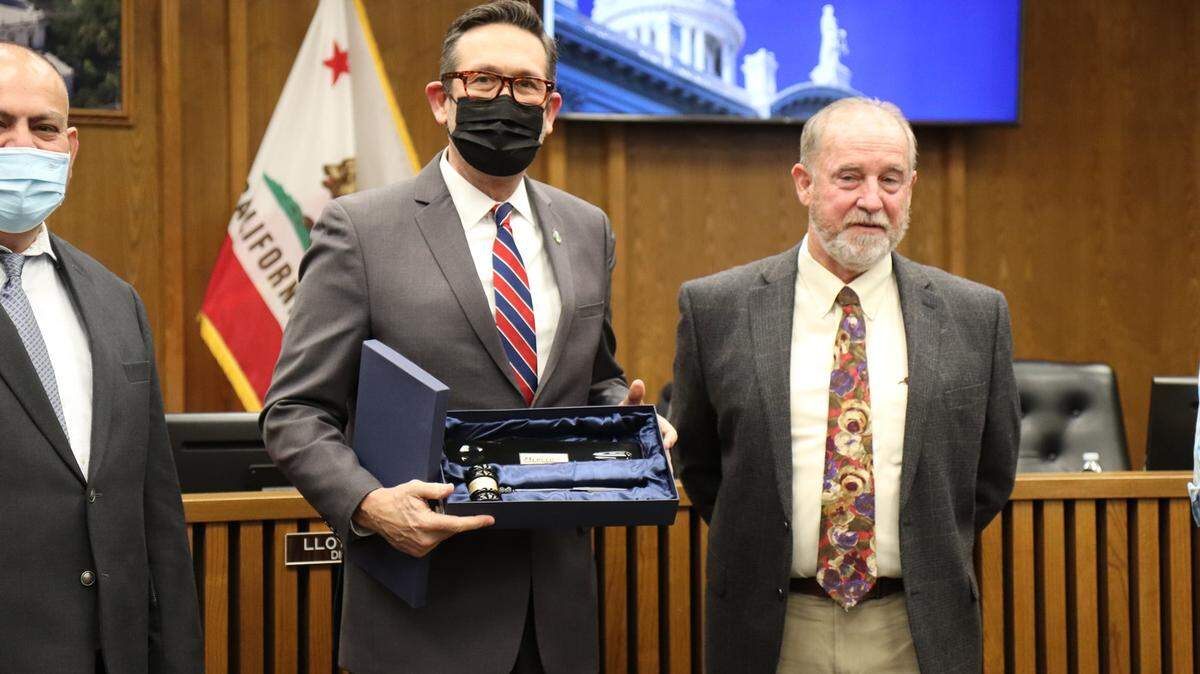 District 3 Supervisor Daron McDaniel, who served as board chair during 2021, is shown passing the leadership gavel to District 4 Supervisor Lloyd Pareira on Tuesday, Jan. 11, 2022.