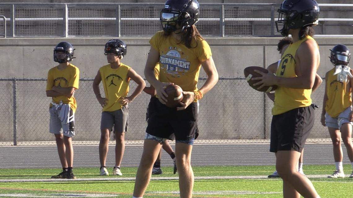 Sunnyside QB Tanner Wilson, left, goes over practice on Wednesday, Aug. 10, 2022.