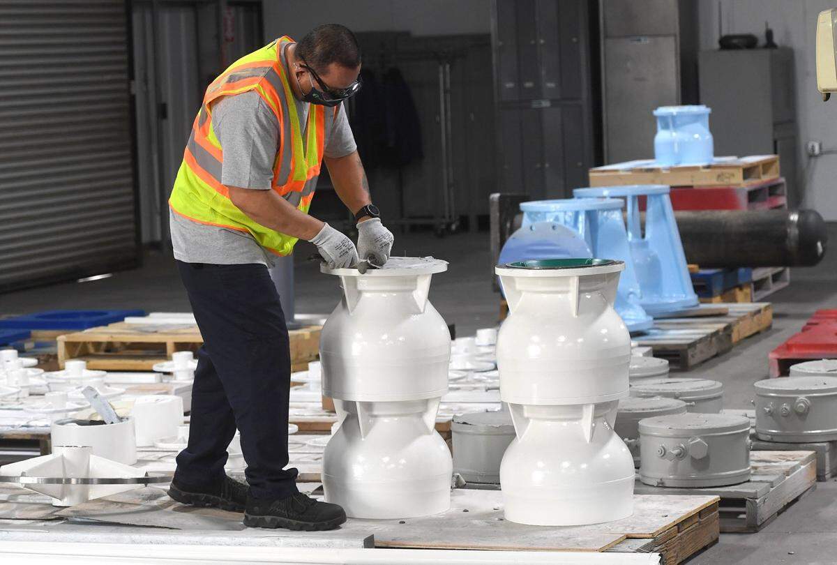 A Trillium Flow Technologies worker finishes pump fittings for shipment in this photo from 2020. Trillium, a global designer, manufacturer and aftermarket services provider of engineered valves and pumps used in energy and broader industrial applications, announced the merger of its facility in Salt Lake City, Utah to Fresno, with Fresno as its headquarters.
