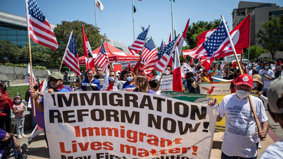 About 200 people march in front of Fresno City Hall in support of immigration reform on Sunday, May 1, 2022.