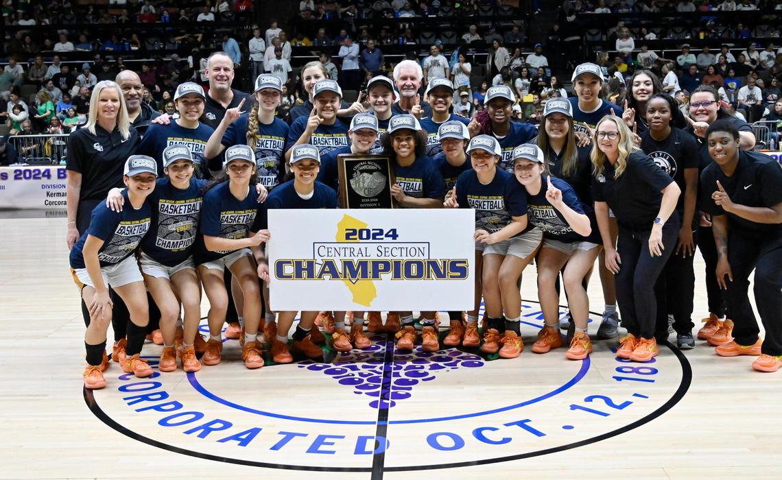 Clovis West poses after defeating St. Joseph 45-41 in the Division I basketball championship Saturday, Feb. 24, 2024 at Selland Arena in Fresno.