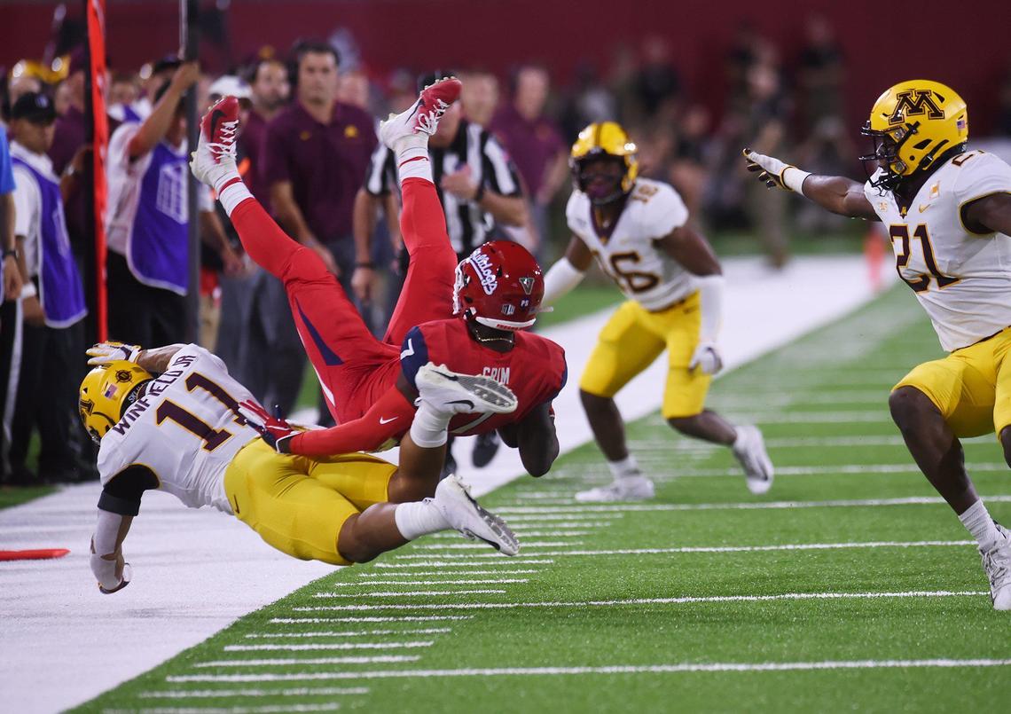 Fresno State wideout Derrion Grim, top center, is tackled by Minnesota’s Antoine Winfield, Jr., left, Saturday, Sept. 7, 2019 in Fresno. Minnesota led 14-10 at halftime