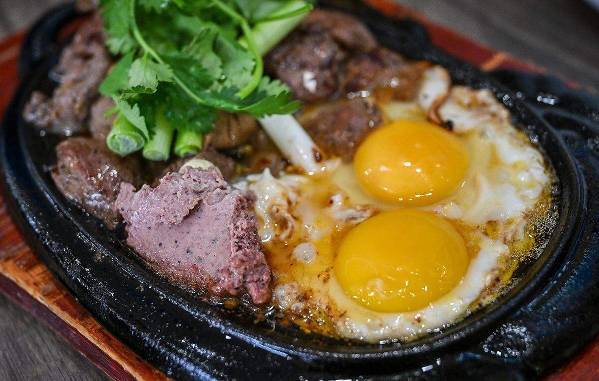 Sizzling steak, egg and pate is one of the non-pho options at Nho Kitchen in the Mayfair Center at First and McKinley in Fresno on Tuesday, Dec. 2, 2025.