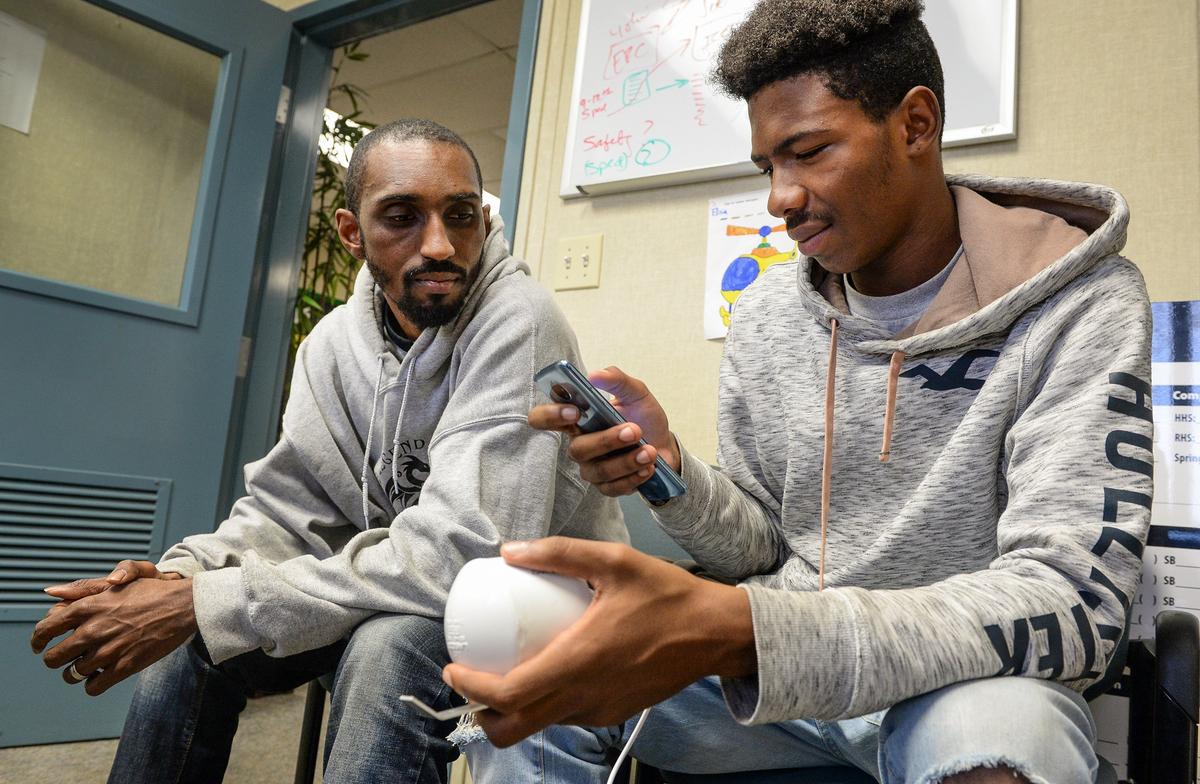 Kieshaun White, right, an 18-year-old who grew up in SW Fresno and has been detailing differences in air quality between north and south Fresno, configures an air quality monitor with help from his mentor Marcel Woodruff at Phoenix High School on Tuesday, Dec. 11,2 018. White is working to install air quality monitors at high schools throughout Fresno Unified School District and developing an app so people can check air quality in real time on those school campuses.