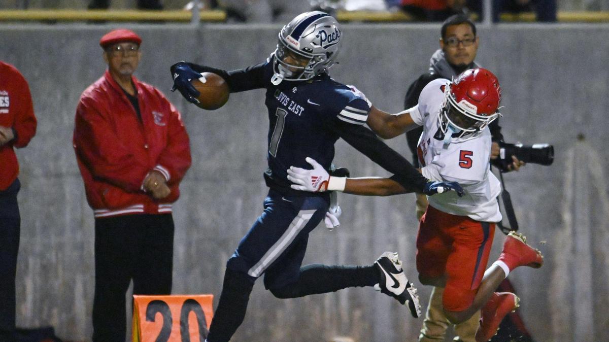 Clovis East’s Tommy Nix, left, is tackled by Sanger’s Marquis Cropper to the right, in a Central Section Division I quarterfinal game Thursday, Nov. 9, 2023 in Clovis.