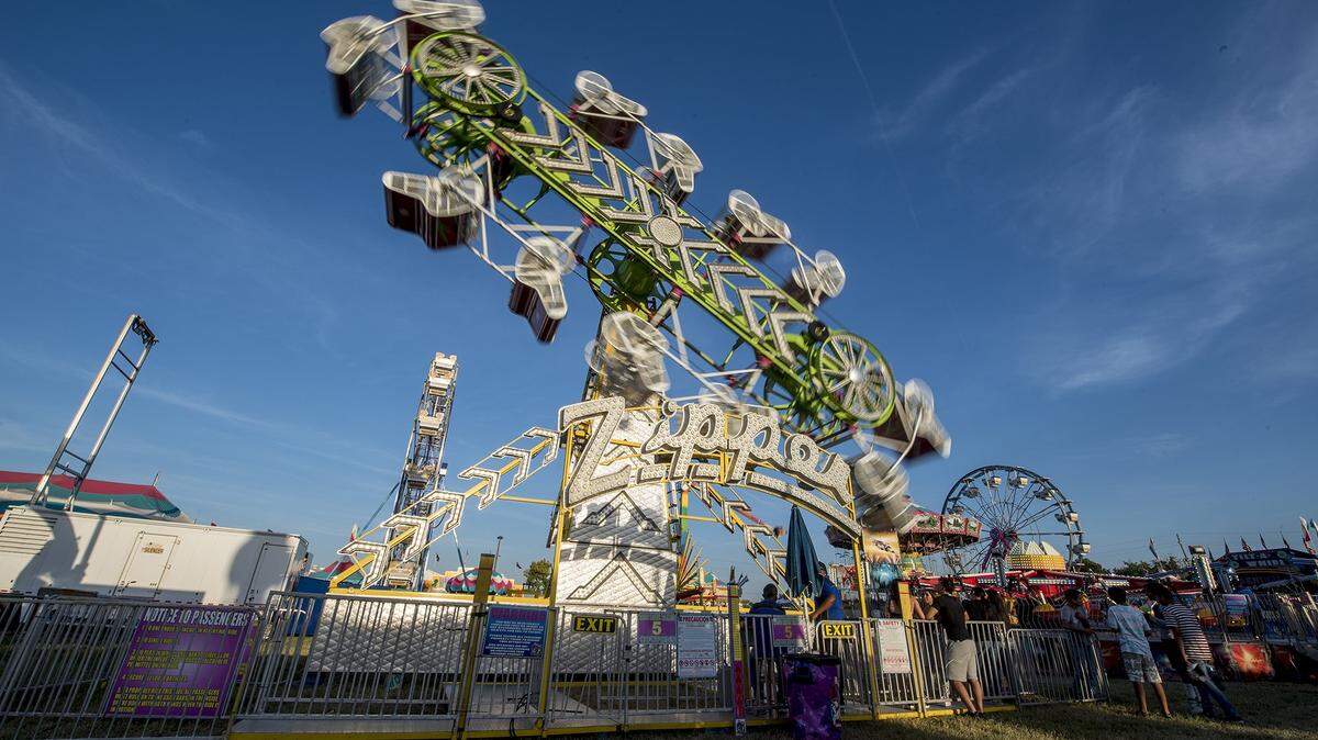 Riders are tumbled around on the Zipper ride during the opening night of the Merced County Fair in Merced, Calif., on Wednesday, June 5, 2019.