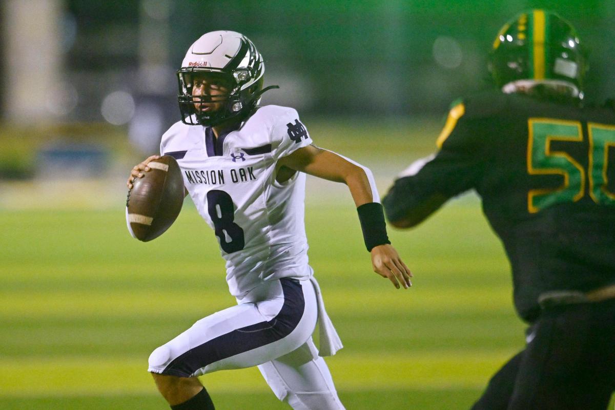 Mission Oak quarterback Daniel Gonzalez, left, scrambles from Roosevelt’s defense Friday, Sept. 1, 2023 in Fresno. Mission Oak won, 31-7.