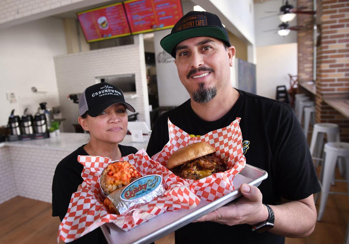 Owners Dean Martin, right, and Tracy Wade, left, hold a tray with food inside The Quirky Cafe, located at L and Kern Streets in downtown Fresno. The restaurant is temporarily closed until foot traffic picks up downtown but the food truck of the same name is alive and well. Photographed Tuesday, Jan. 28, 2020 in Fresno.