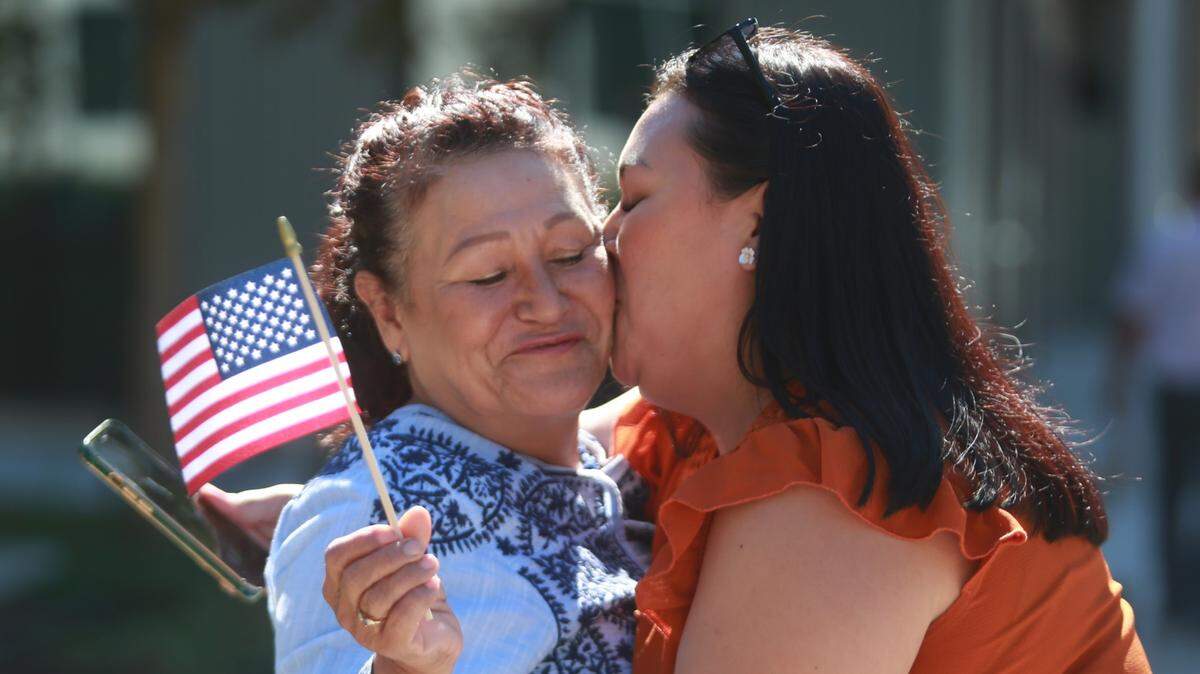 Jéssica Rodríguez kisses her mother Mercedes Heredia who became a US citizen Thursday (Sept. 22) at the offices of the United States Citizenship and Immigration Services in Fresno.