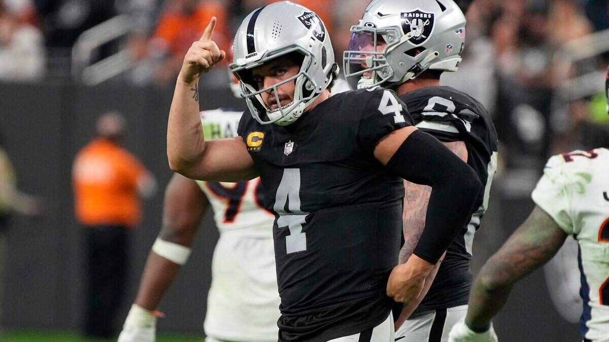 Las Vegas Raiders quarterback Derek Carr motions against the Denver Broncos during the second half of an NFL football game, Sunday, Dec. 26, 2021, in Las Vegas.