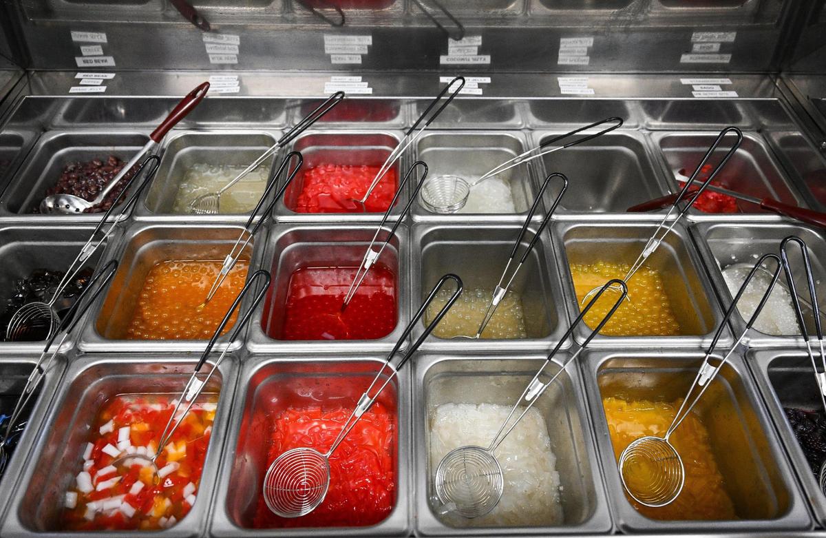 Various bobas and flavors fill trays at Bubble Pop Tea in Fresno where customers are greeted with a K-pop theme and a variety of drinks.