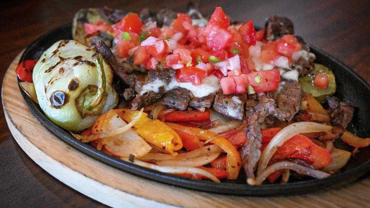 Nopal montado is a dish made with grilled cactus and skirt steak and topped with cheese, tomatoes, onions and peppers at Fuego Taqueria y Restaurante in Fresno. The specialty plate is served with homemade tortillas, rice and beans.