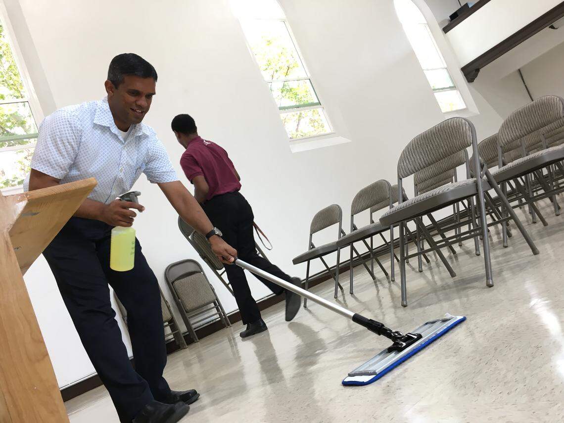 Peter Uchil, missionary with the World Society Church of God in Fresno, California, wipes the floors of the church on Tuesday, Aug. 7, 2018 before evening service. The church has faced online rumors about human trafficking that church members say are not true. Police in Fresno have not been able to find credible evidence of the rumors.