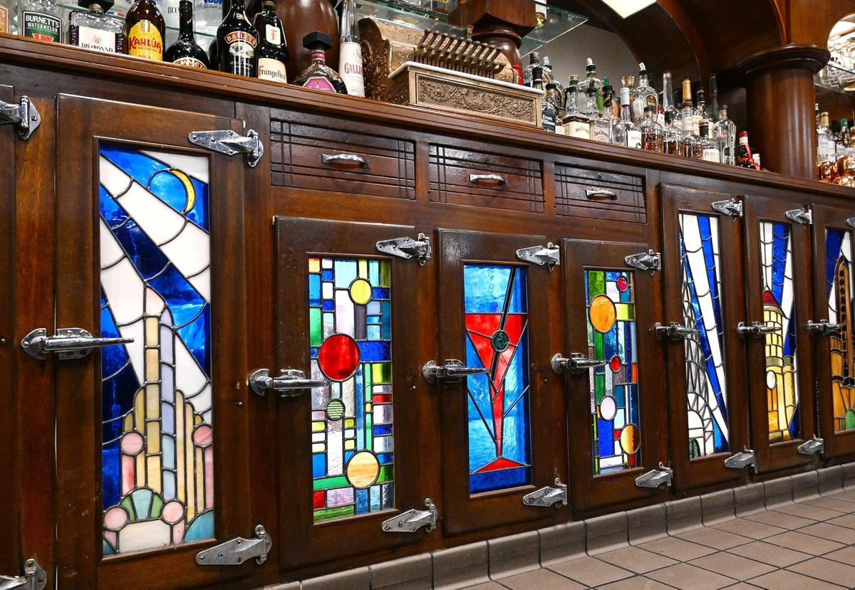 Stained glass doors at Cosmopolitan Tavern & Italian Grill’s backbar are recreations of the originals. Photographed in downtown Fresno Friday, Oct. 25, 2024.