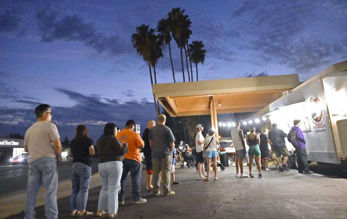 Customers stand in line to order from Tacos El Cabezon at Shaw and Maroa avenues Wednesday, Sept. 24, 2025 in Fresno.