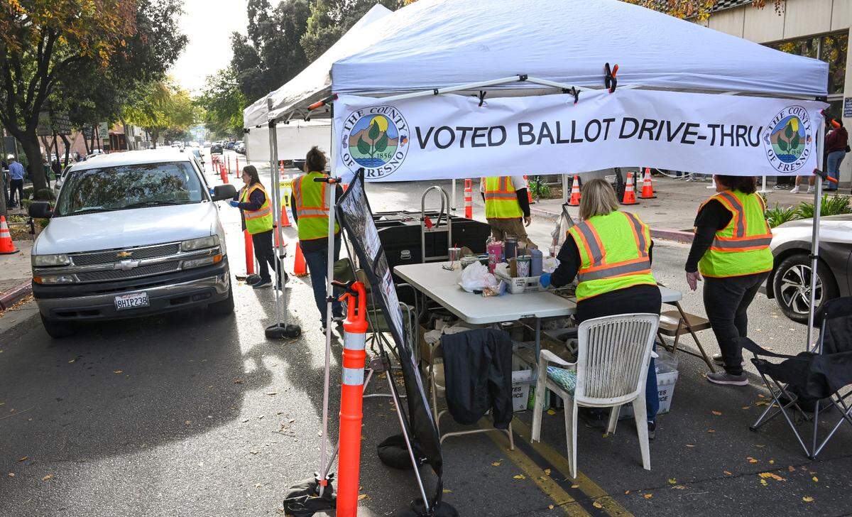 Voters drive up to a voted ballot drive-thru on Kern Street where they could turn in their already filled-out ballots outside the Fresno County Clerk/Registrar of Voters department in downtown Fresno on Election Day, Tuesday, Nov. 5, 2024.
