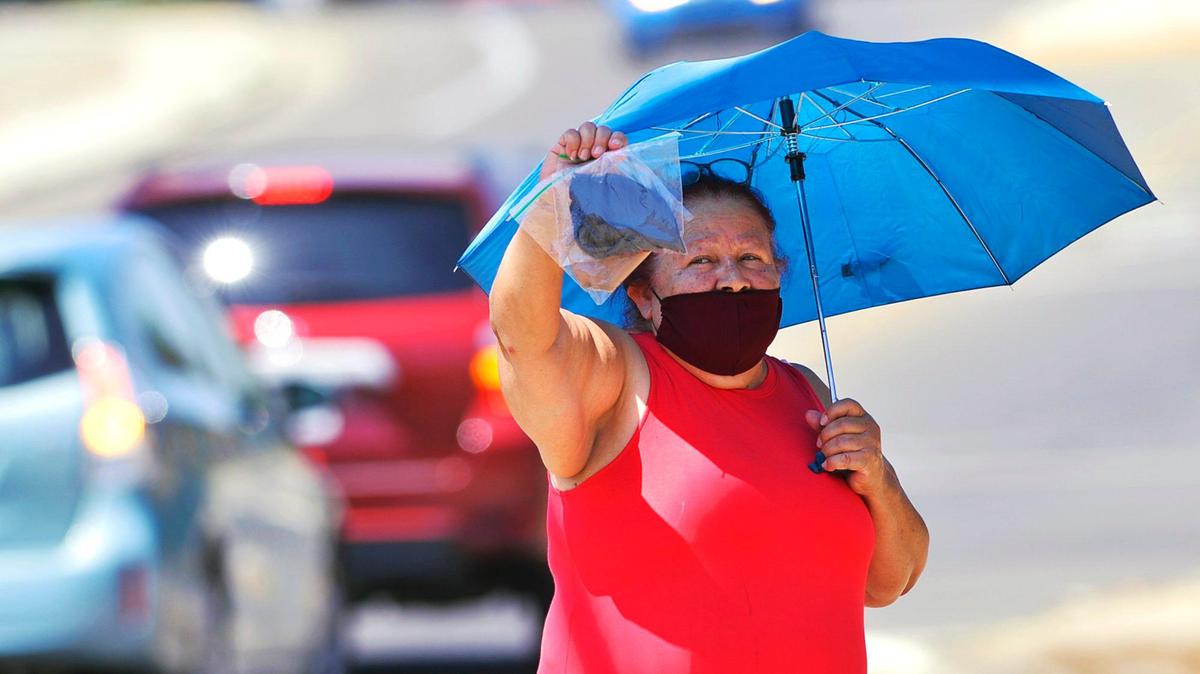 Julia Garcia sells masks along Ashlan Avenue in Fresno.
