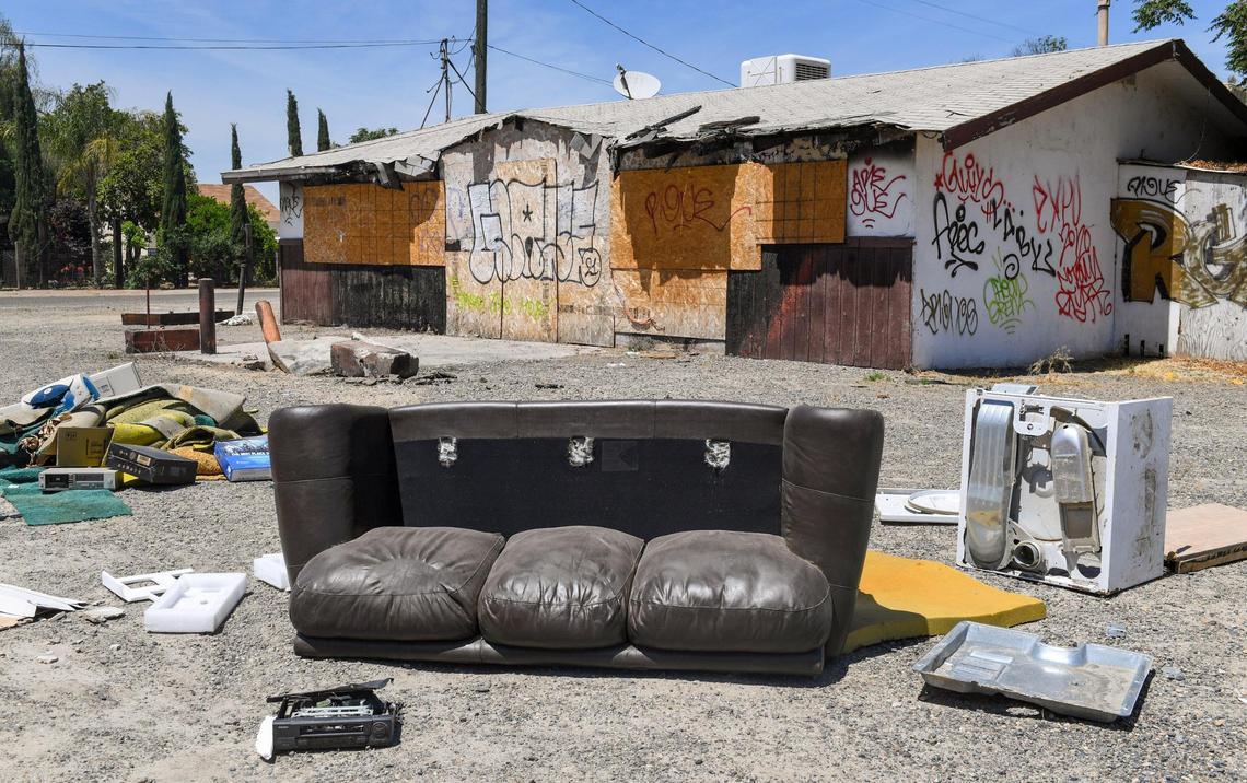 An illegal dump, including appliances, mattresses, computer equipment, furniture and chemical containers, is shown strewn in front of a closed country grocery store at the corner of McKinley Avenue at Bryan west of Fresno on Friday, April 30, 2021.