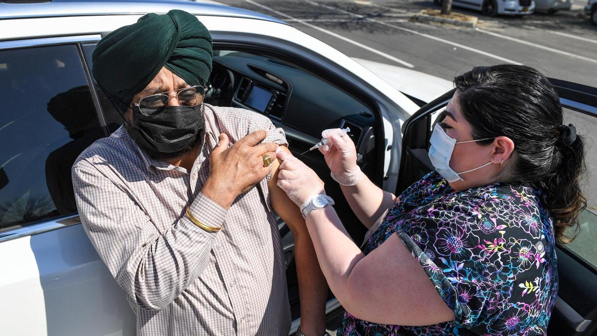 Jagdeep Sra of Fresno has his Johnson & Johnson COVID-19 vaccination shot administered by nurse Marivel Reyes during a drive-up vaccination and resource fair for over 1000 Punjabi food and agriculture workers at the Sikh Center of the Pacific Coast Gurdwara in Selma, on Saturday, March 27, 2021.