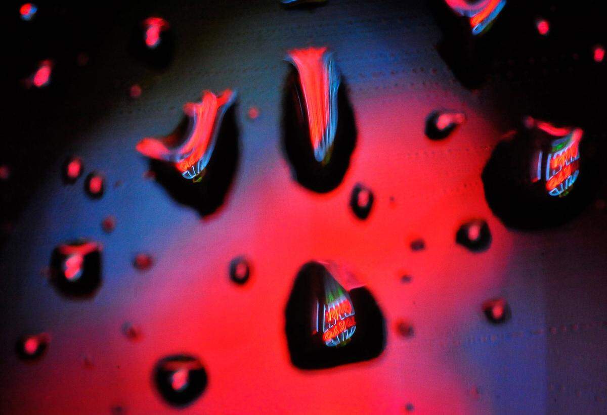 The iconic neon glow of Tokyo Gardens restaurant on Fulton Street in Fresno is seen through raindrops on a car window during a 2015 storm.