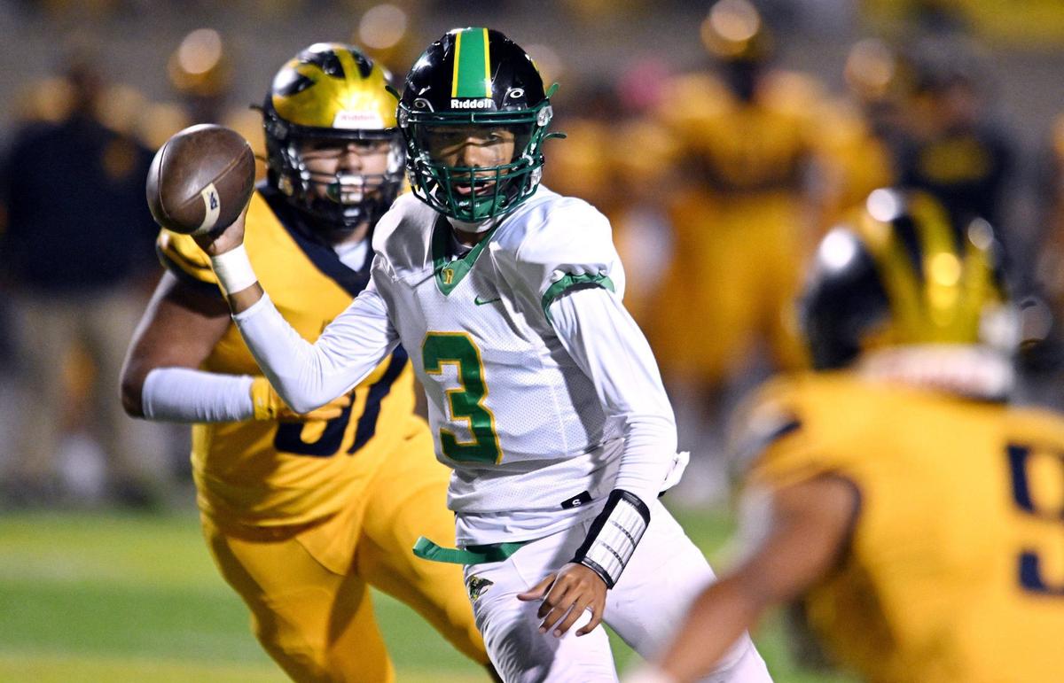 Roosevelt quarterback CJ Barker, center, looks to pass before keeping the ball and running it in for the two-point conversion against Sunnyside Friday, Oct. 4, 2024 in Fresno.