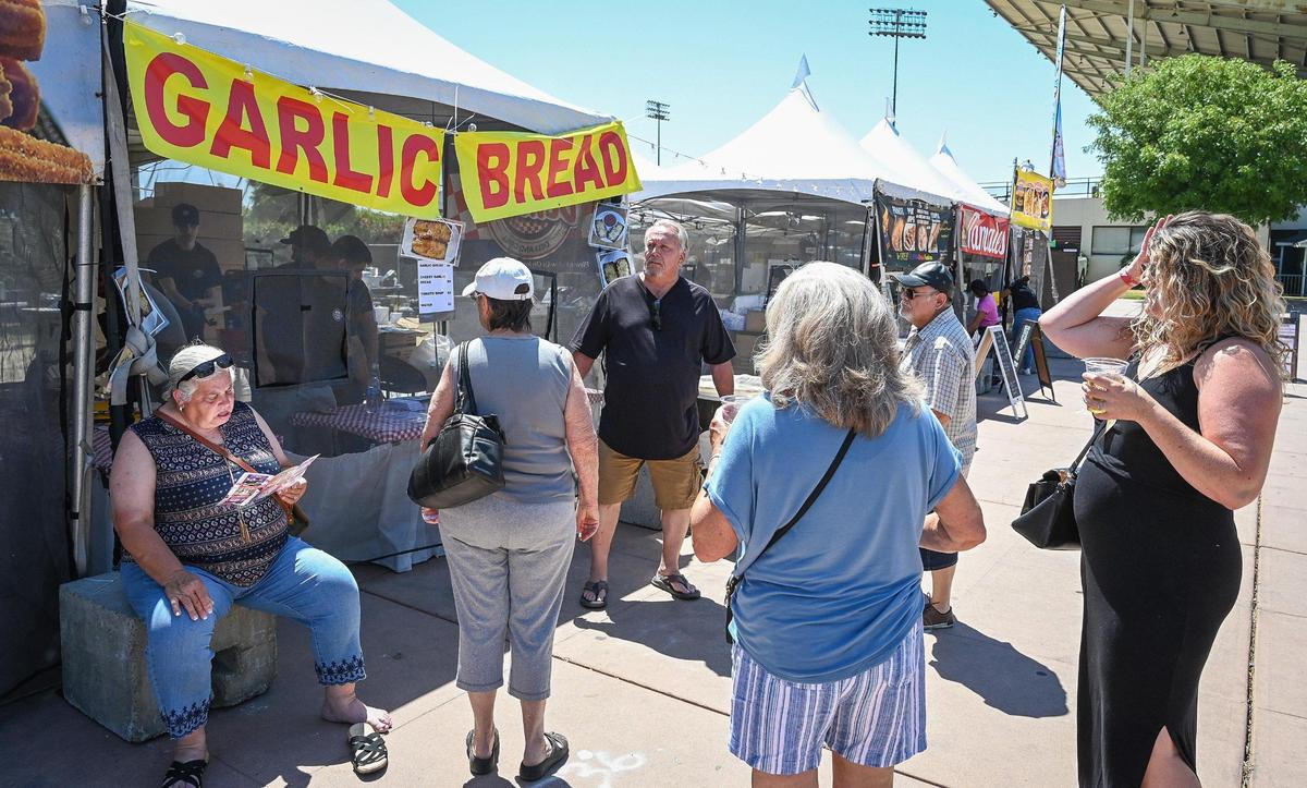 Visitors wait for garlic bread to be prepared on day one of the National Garlic Festival at the Fresno Fairgrounds on Friday, May 13, 2022.