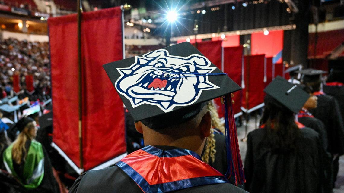 A graduate wears a bulldog mascot on his cap while walking through Fresno State’s College of Arts & Humanities graduation ceremony at the Save Mart Center on May 19, 2023. A new version of the Measure E sales tax initiative appears headed to the March 2024 ballot after its narrow failure in November 2022.