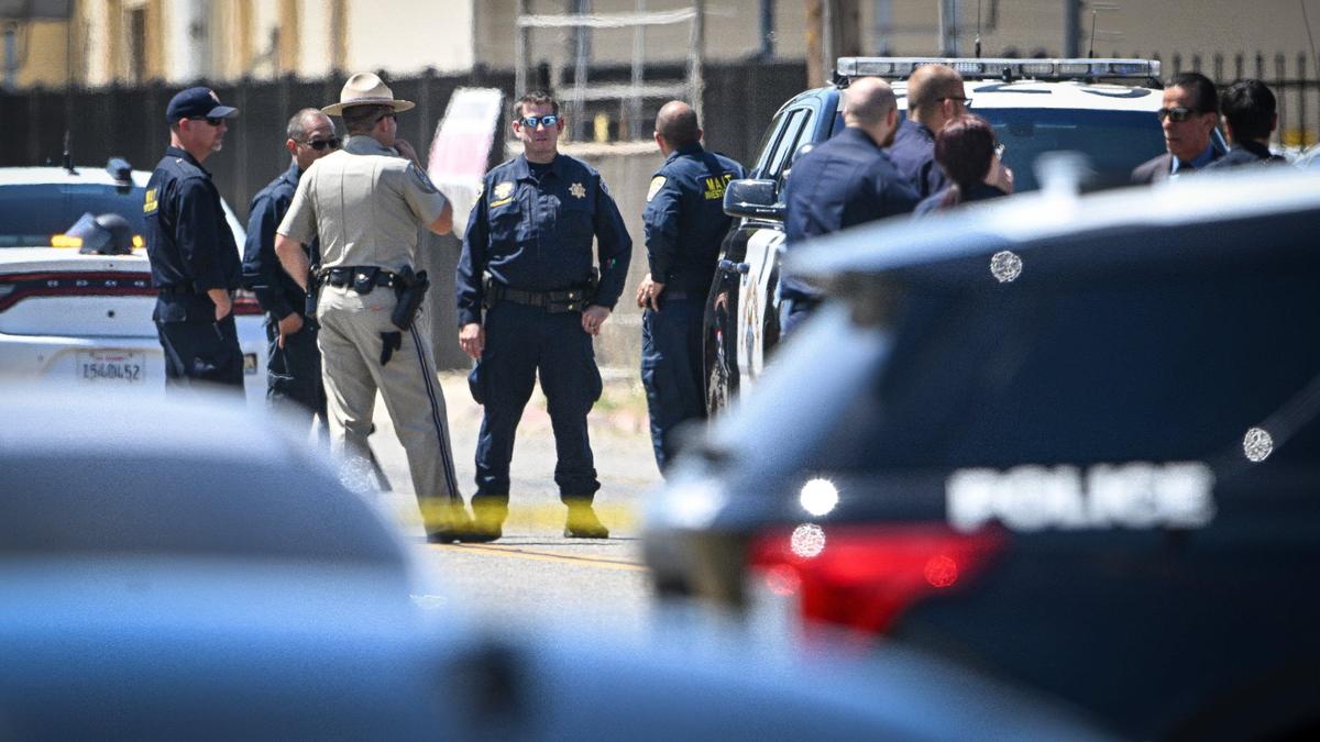 Police investigators gather at the scene of an officer-involved shooting on Cherry Avenue south of Jensen in south Fresno on Friday, May 24, 2024.