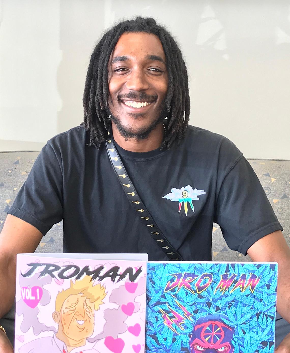 Former Fresno State linebacker Ejiro Ederaine shows off the first two episodes of his JroMan comics series.