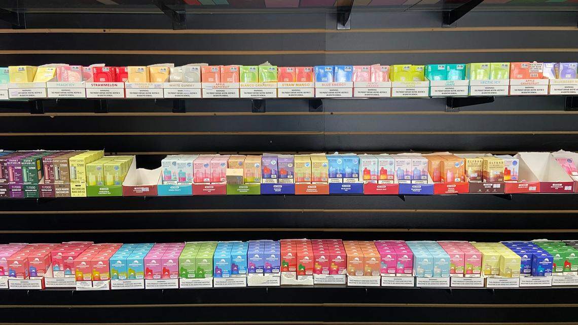 Rows of flavored tobacco vape juice, including varieties banned by Proposition 31, are displayed on the wall of a central Fresno smoke shop as seen on Oct. 18, 2023.