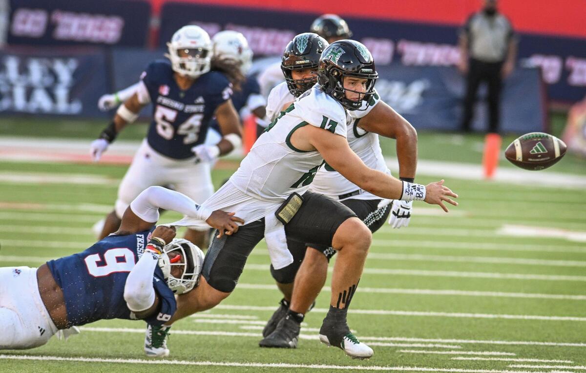 Fresno State’s Malachi Langley, left, forces Hawaii quarterback Brayden Schager to fumble the ball during the first half of their game at Valley Children’s Stadium in Fresno on Saturday, Nov. 2, 2024.