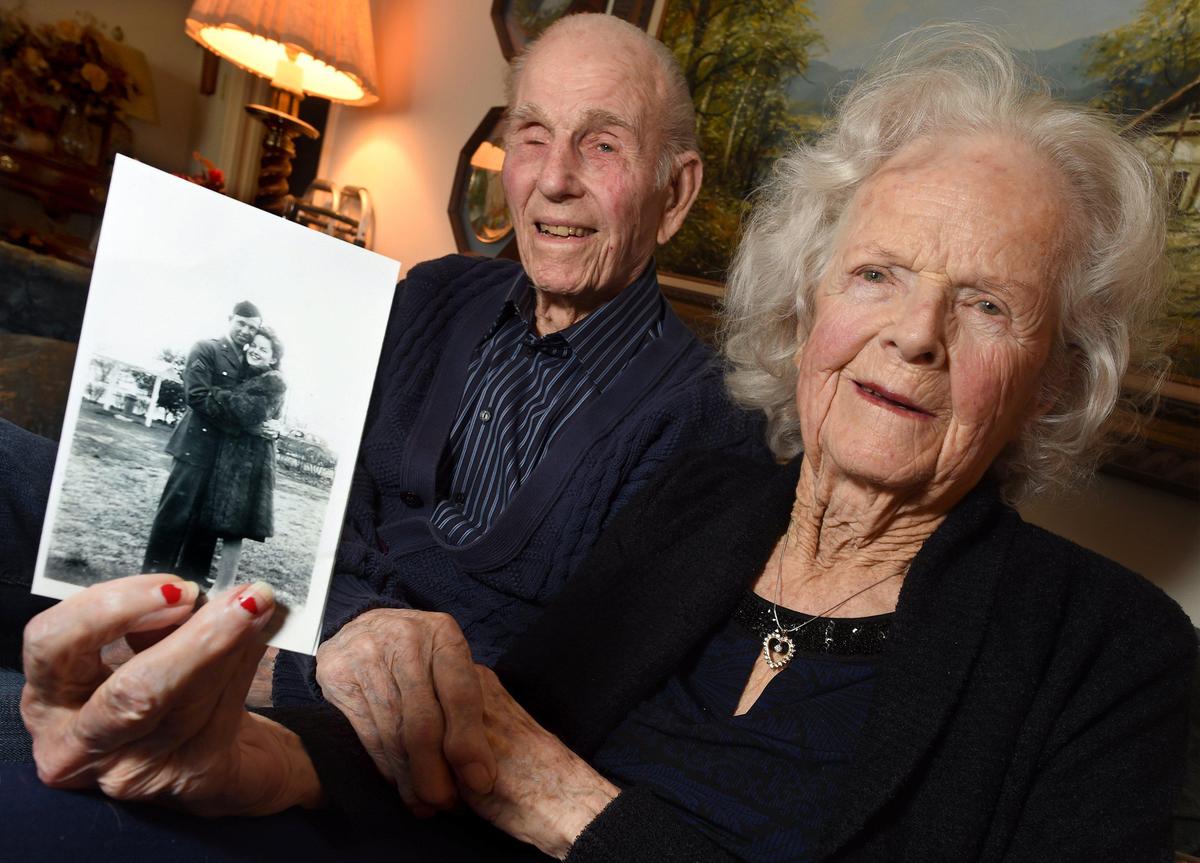 Marian Olesen, 100, holds a photo of her and her husband Arthur Olesen, 101, as newlyweds in 1945. The couple just celebrated their 75th wedding anniversary.