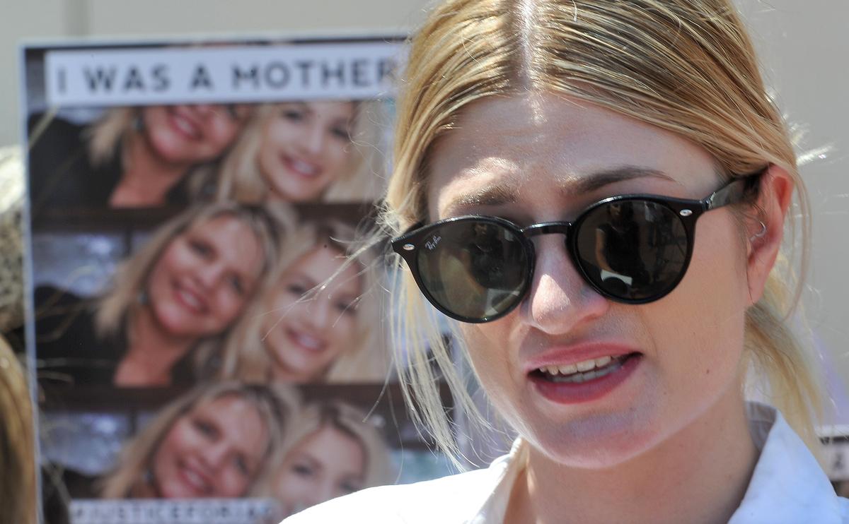 Alison Dupras, daughter of Jennifer Dupras and granddaughter of Cynthia Houk, who were killed in December, is interviewed by the media during a silent protest with family and friends outside the Fresno County District Attorney’s office, Monday morning, July 23, 2018.